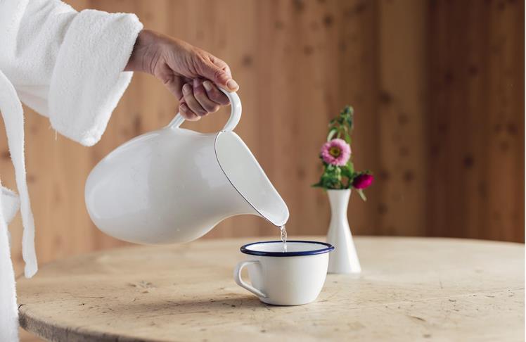 A woman prepares herself some tea in the Vital Lounge