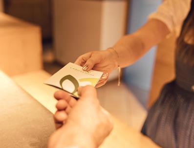 A receptionist hands over a room key